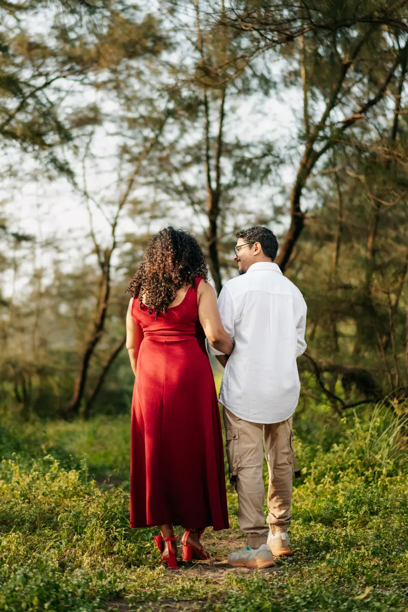 Bride and groom smiling together by a lake at golden hour